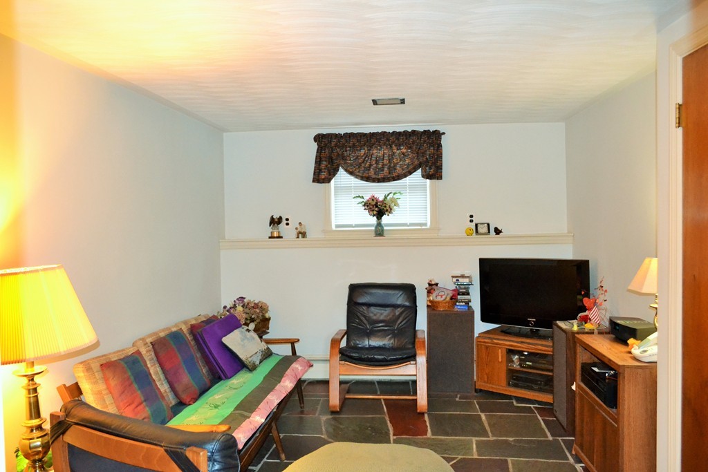 10 Crestline Circle Beverly, MA 01915 - Photo 19 of 22 a living room with furniture and a flat screen tv
