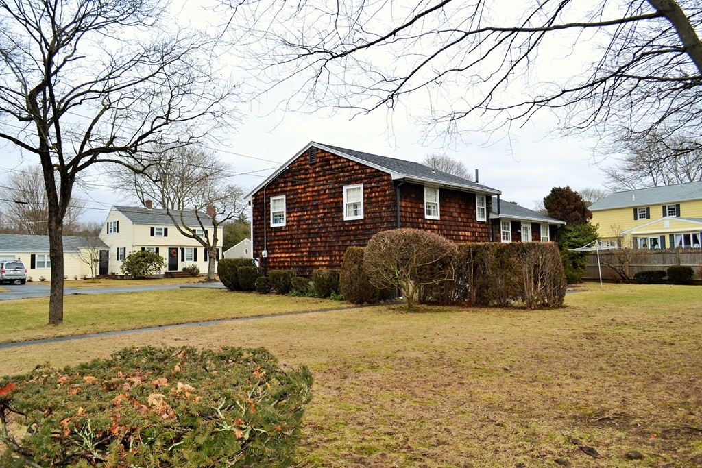 10 Crestline Circle Beverly, MA 01915 - Photo 21 of 22 a front view of a house with a yard covered with snow and trees