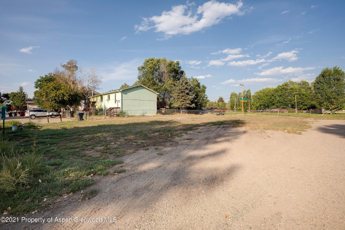 0 Washington Street Craig, CO 81625 - Photo 8 of 12 a front view of a house with a yard and trees