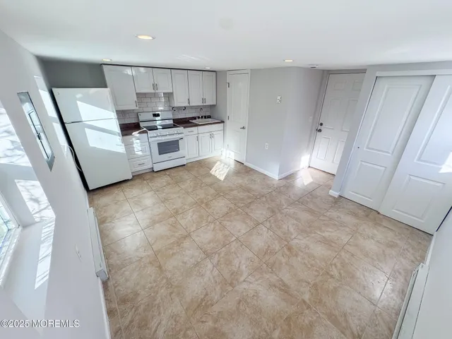 a view of a livingroom with wooden floor and a flat screen tv
