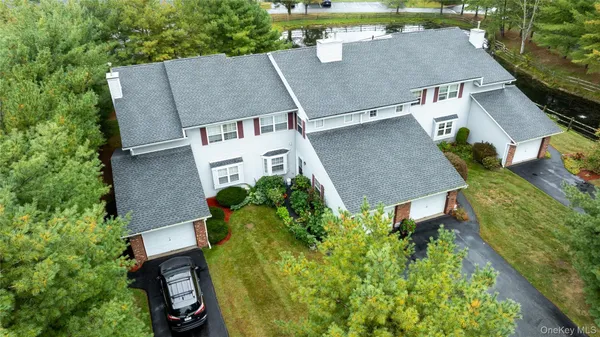 an aerial view of a house with garden space and street view