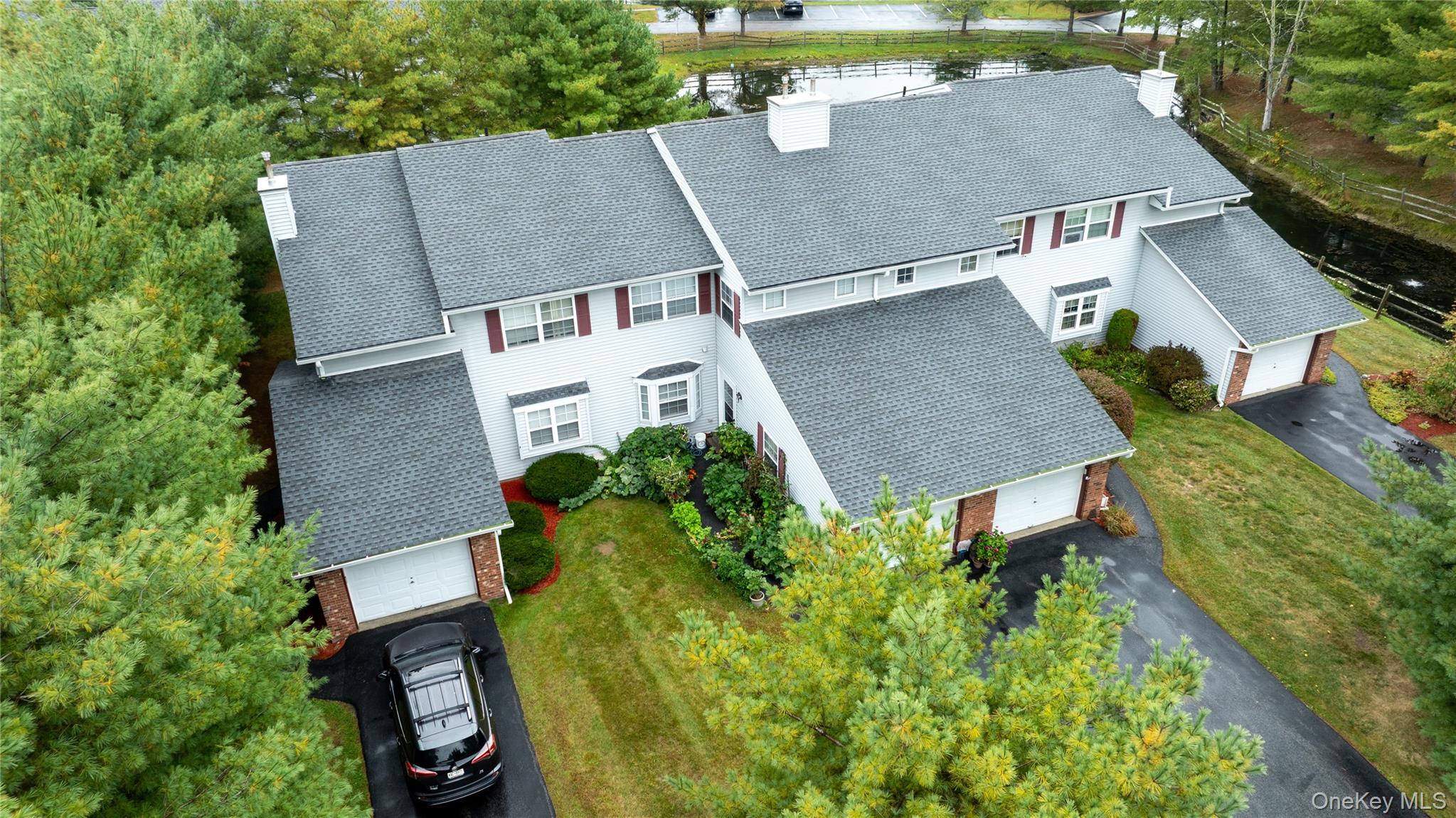 an aerial view of a house with garden space and street view