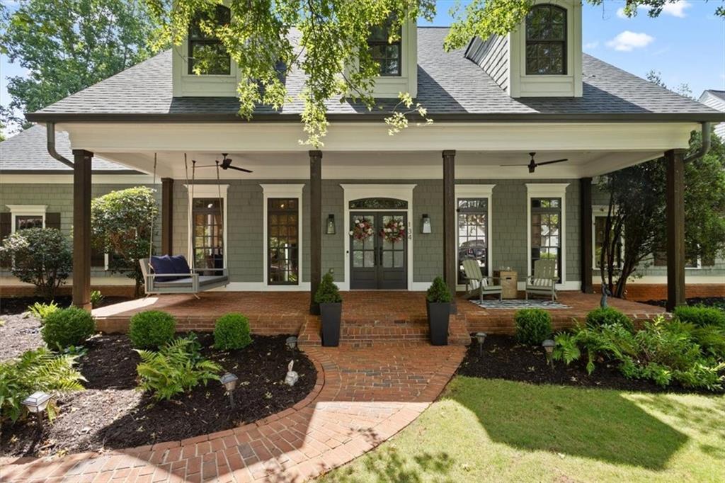 134 Prospector Ridge Dahlonega, GA 30533 - Photo 1 of 96 front view of a brick house with a large window and potted plants