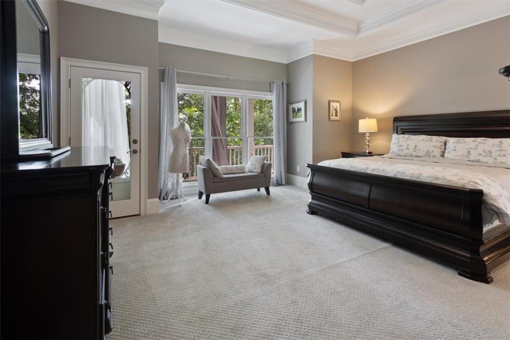 134 Prospector Ridge Dahlonega, GA 30533 - Photo 32 of 96 a spacious bedroom with a bed and glass door