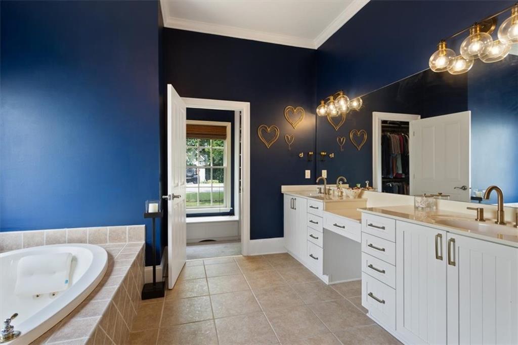 134 Prospector Ridge Dahlonega, GA 30533 - Photo 39 of 96 a spacious bathroom with a tub sink and mirror