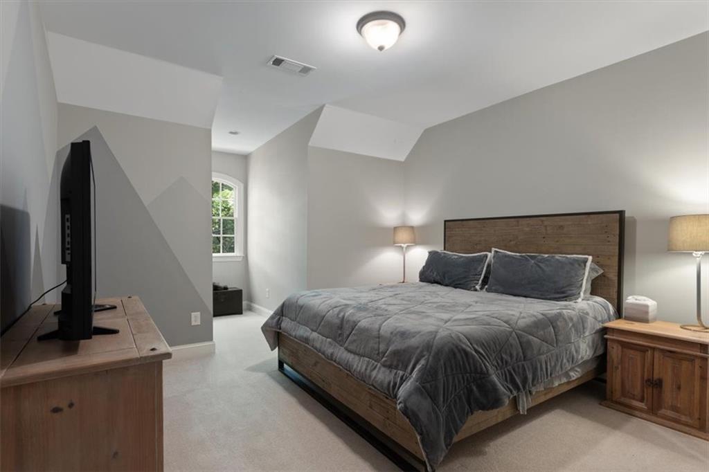 134 Prospector Ridge Dahlonega, GA 30533 - Photo 54 of 96 a bedroom with a bed and a flat tv screen on dresser