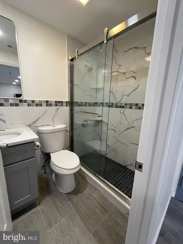 a bathroom with a toilet a sink and shower
