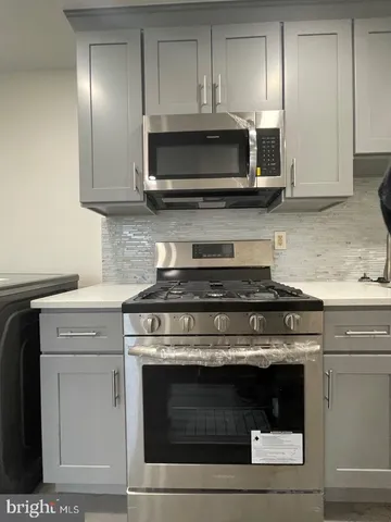 a close view of a stove top oven and cabinets