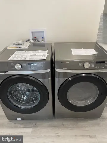 a kitchen with counter top space and wooden floor