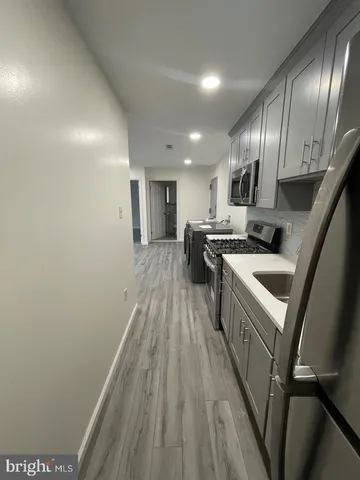 a view of a utility room with cabinets