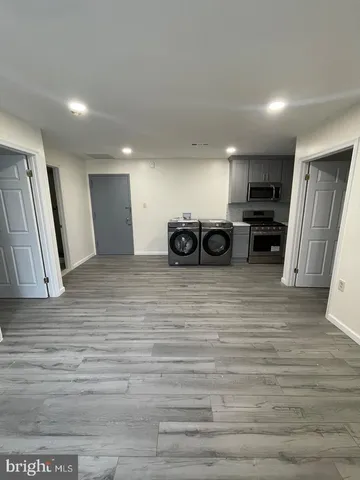 a view of a kitchen with a stove top oven