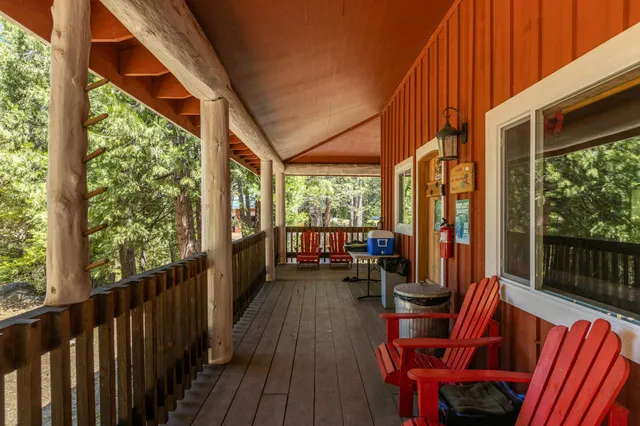 a view of balcony with chairs and wooden fence