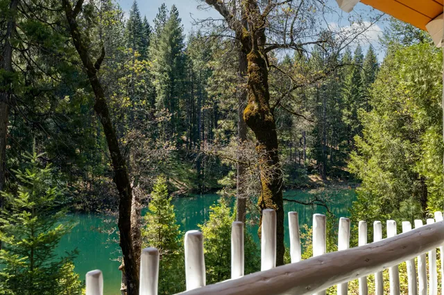 a view of a house with a tree in the background