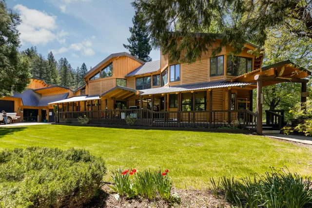 a view of a house with swimming pool and a yard