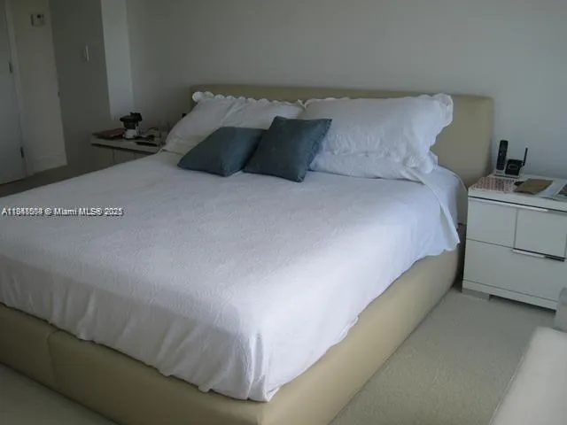 a bed sitting in a bedroom and lamp