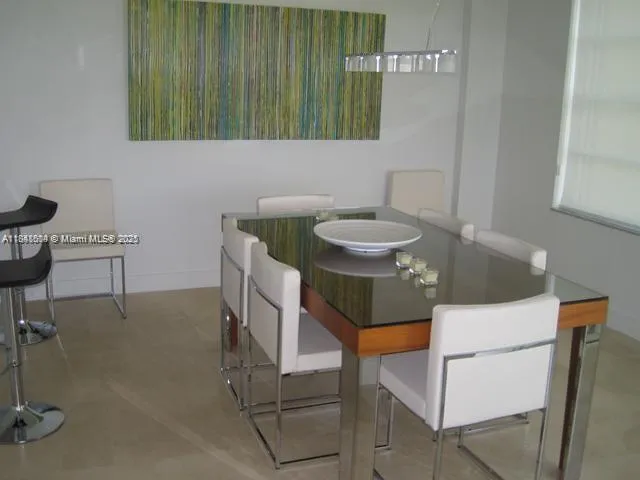 a bathroom with a sink a table and chairs