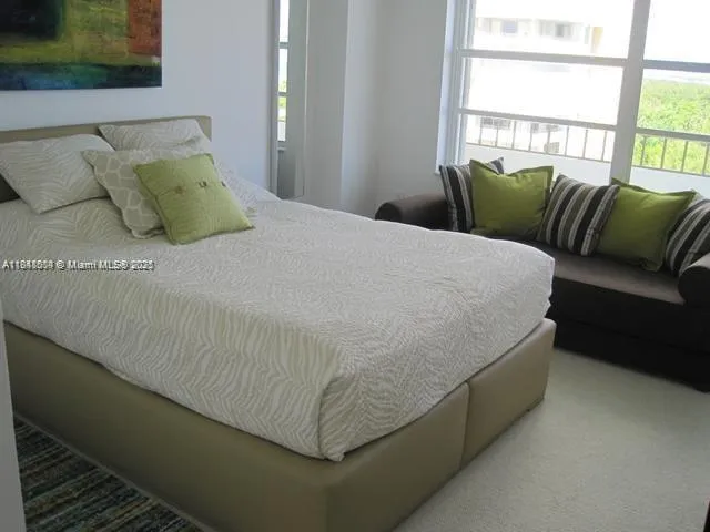 a bed sitting in a bedroom next to a window