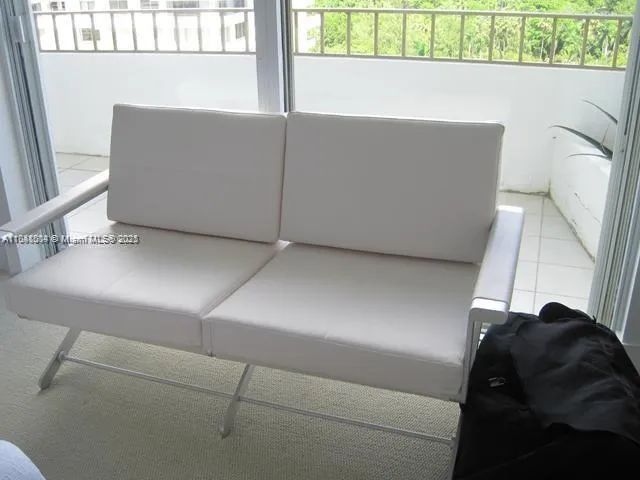a living room with a couch and a stove next to a window
