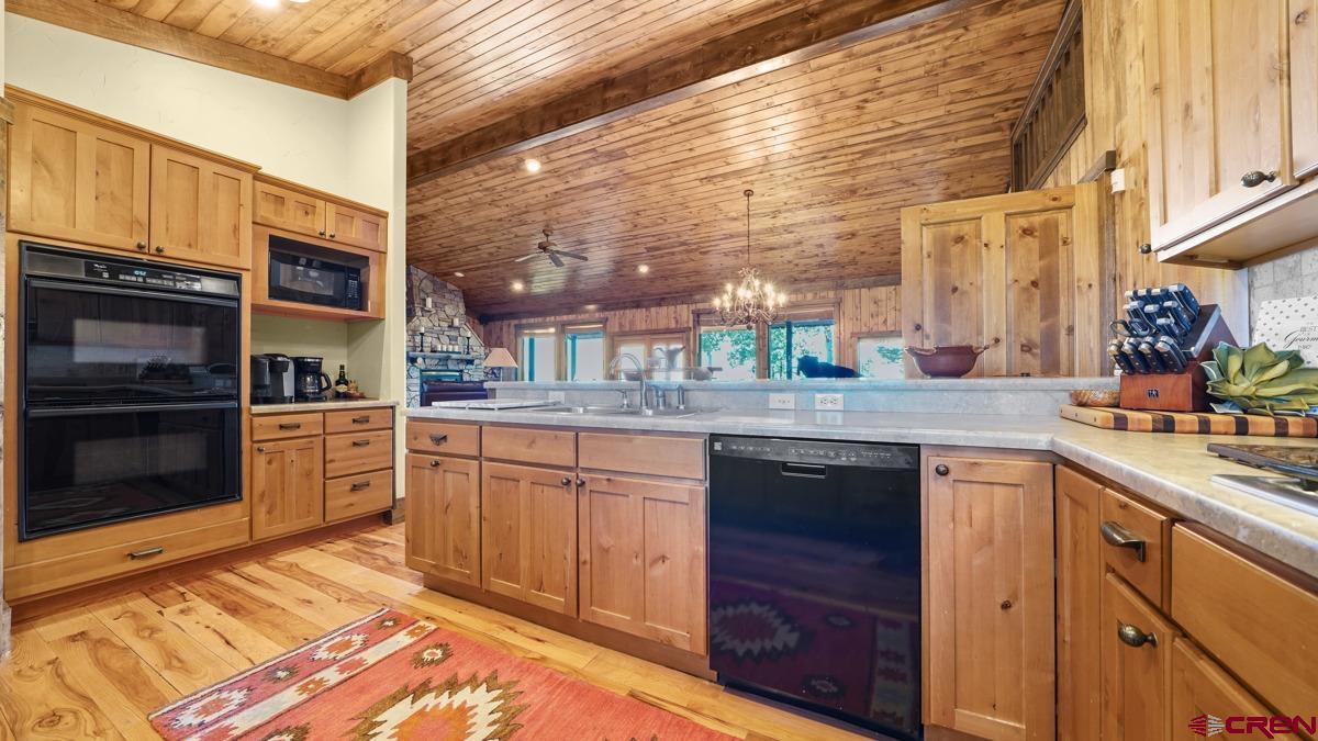 220 Ridge Road Cimarron, CO 81220 - Photo 13 of 45 a kitchen with stainless steel appliances granite countertop a stove a sink and a microwave