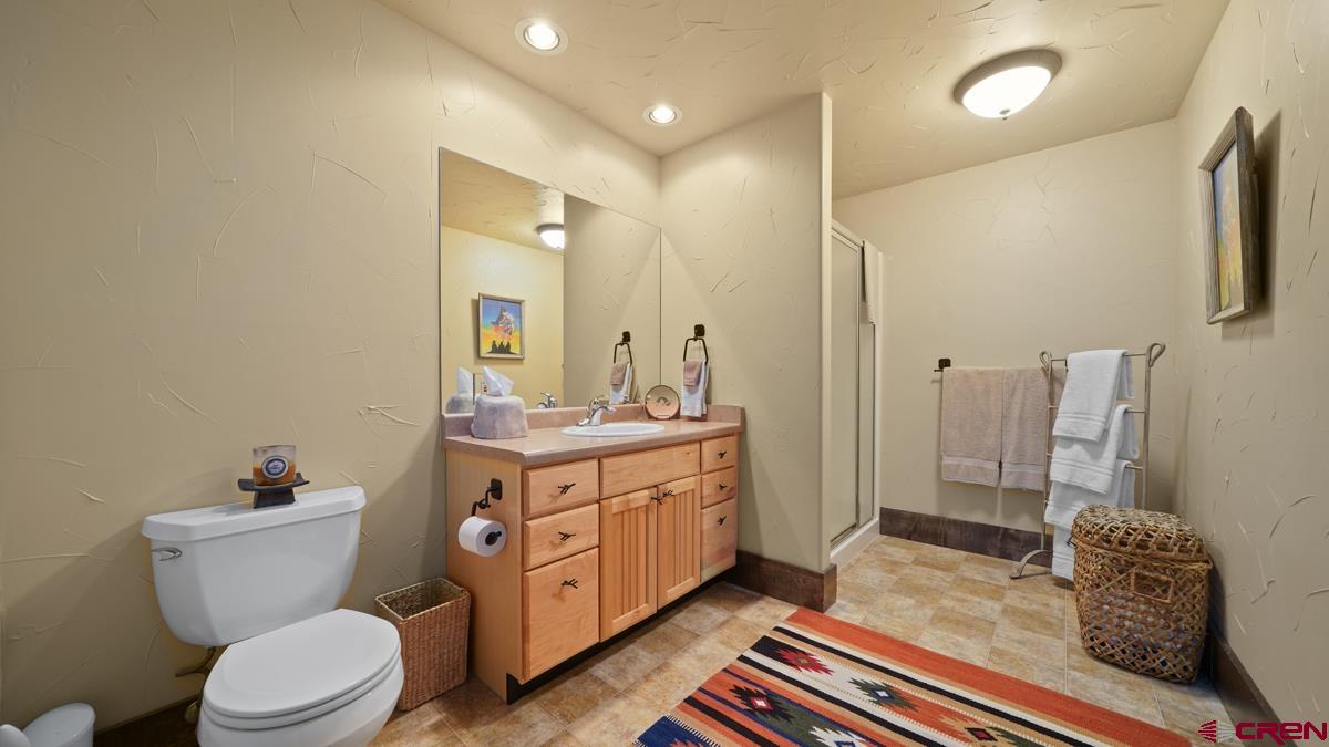 220 Ridge Road Cimarron, CO 81220 - Photo 24 of 45 a spacious bathroom with a double vanity sink toilet and shower