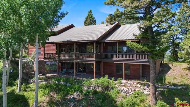a front view of a house with yard and green space