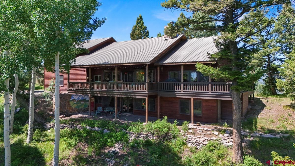 220 Ridge Road Cimarron, CO 81220 - Photo 3 of 45 a front view of a house with yard and green space
