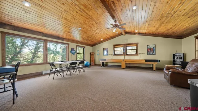 a view of a livingroom with furniture and a ceiling fan