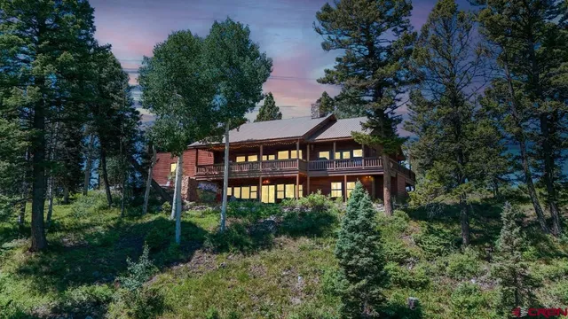 a view of a house with a yard and tree s