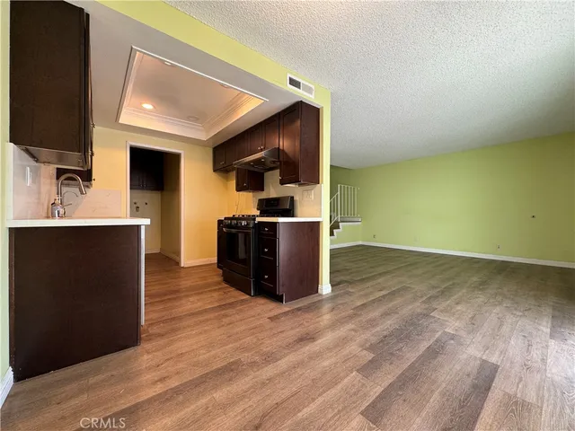 a kitchen with stainless steel appliances granite countertop a sink a stove and a refrigerator