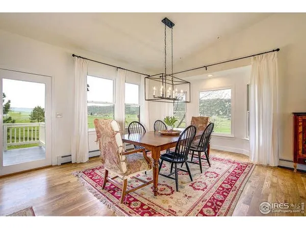 a view of a dining room with furniture window and wooden floor