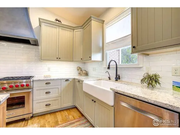a kitchen with granite countertop a sink and a stove