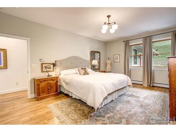 a bedroom with a large bed and a chandelier