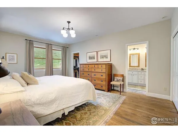 a bedroom with a large bed and a dresser