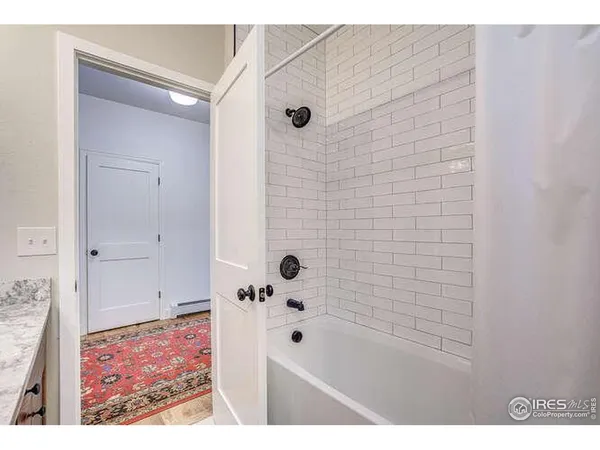 a bathroom with a bathtub and shower