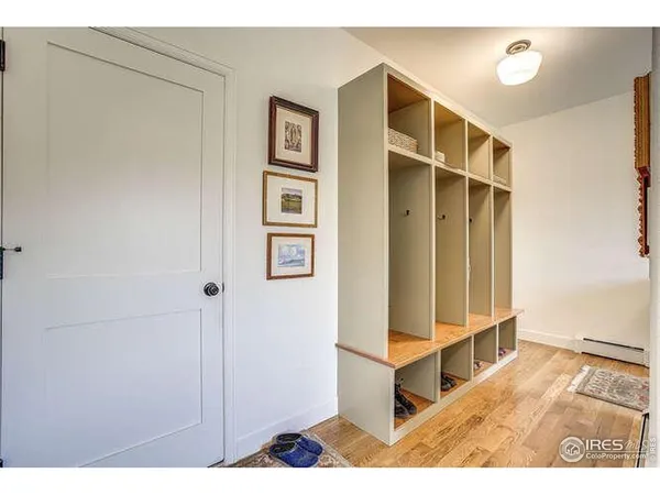 a view of a bedroom with wooden floor and cabinet