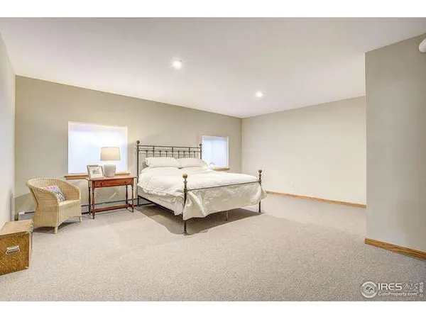 a spacious bedroom with a bed and window