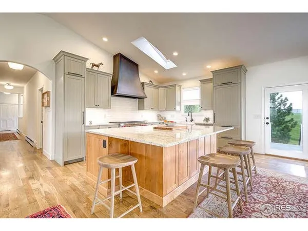 a kitchen with kitchen island granite countertop wooden cabinets and counter space