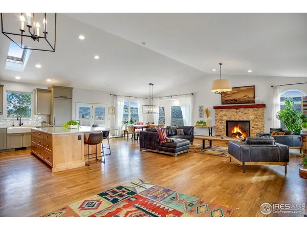 a living room with fireplace furniture and a wooden floor