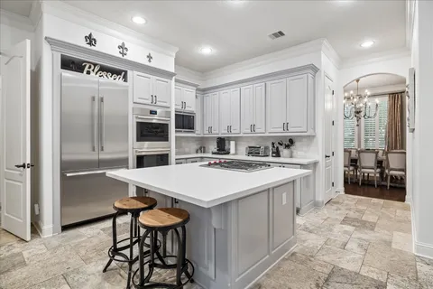 a kitchen with stainless steel appliances a sink stove and refrigerator