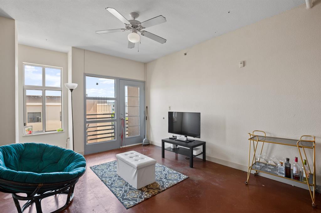 711 West 26th Street, Unit 700 Austin, TX 78705 - Photo 12 of 19 a living room with furniture and a window