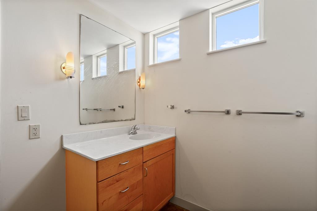 711 West 26th Street, Unit 700 Austin, TX 78705 - Photo 18 of 19 a bathroom with a sink a mirror and a shower