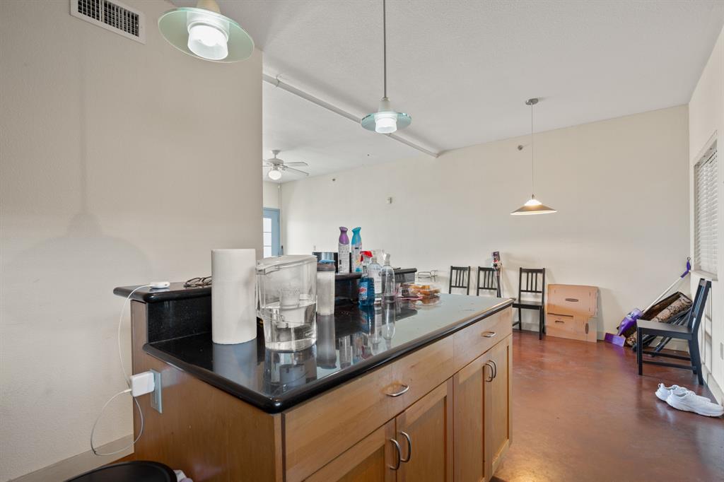 711 West 26th Street, Unit 700 Austin, TX 78705 - Photo 6 of 19 a kitchen with stainless steel appliances granite countertop a sink counter space and living room view