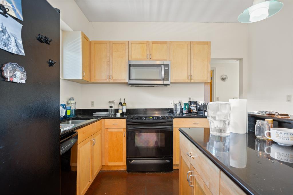 711 West 26th Street, Unit 700 Austin, TX 78705 - Photo 7 of 19 a kitchen with stainless steel appliances granite countertop a stove sink and cabinets