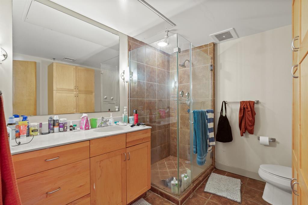 711 West 26th Street, Unit 700 Austin, TX 78705 - Photo 9 of 19 a bathroom with a sink a toilet and shower