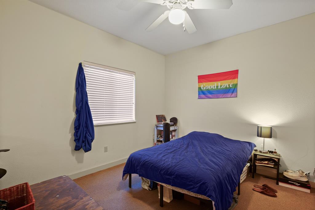 711 West 26th Street, Unit 700 Austin, TX 78705 - Photo 10 of 19 a spacious bedroom with a bed and a chandelier