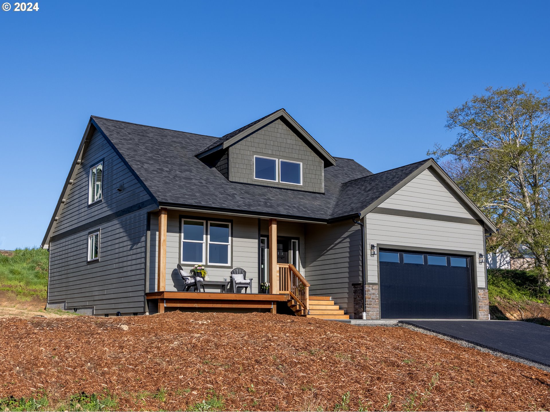 35655 Bella Rdg Loop Astoria, OR 97103 - Photo 1 of 34 a front view of a house with a garden and yard