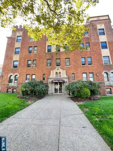 a front view of a building with garden
