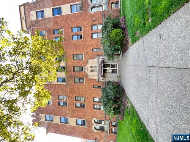 303 Hamilton Place, Unit D4 Hackensack, NJ 07601 - Photo 1 of 9 a front view of a building with garden