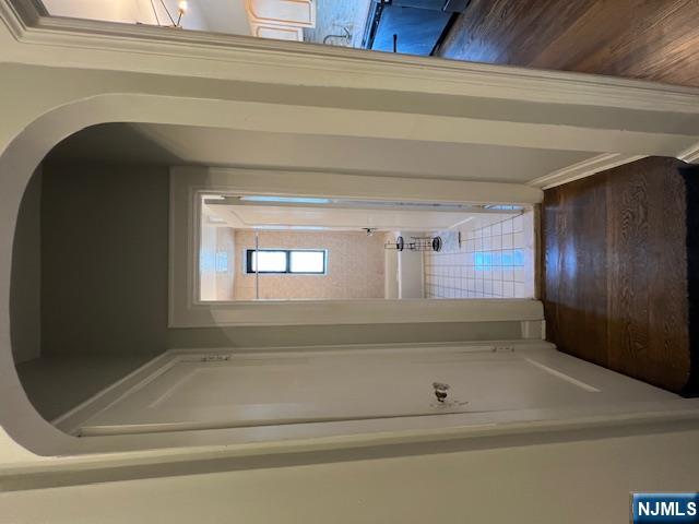 303 Hamilton Place, Unit D4 Hackensack, NJ 07601 - Photo 3 of 9 a view of a hallway with wooden floor and a bathroom