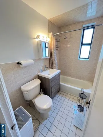 a bathroom with a sink a toilet a mirror and shower
